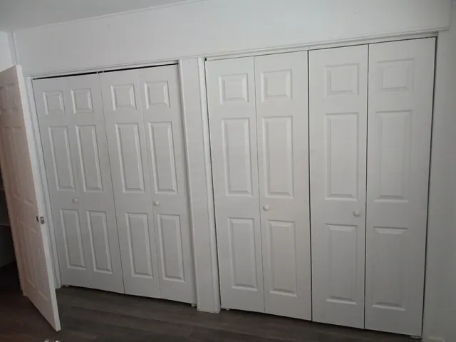 a view of a hallway with wooden floor