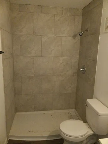 a bathroom with a toilet and a shower