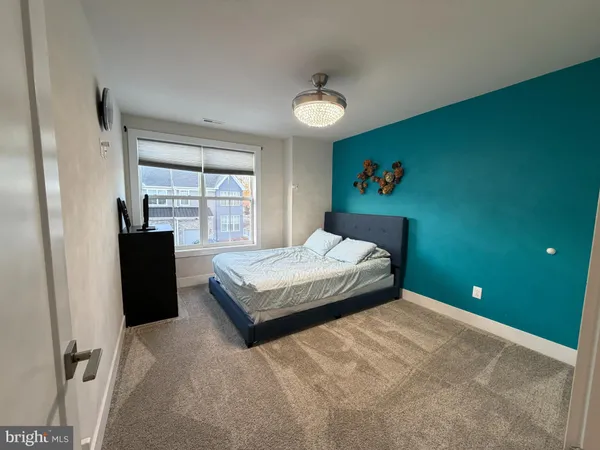 a bedroom with a bed and a large window