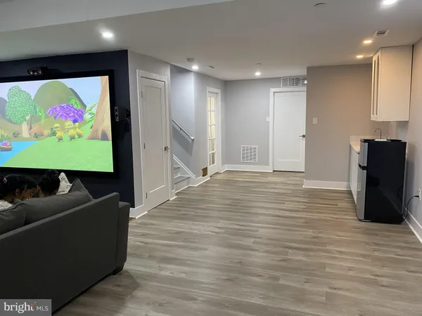a view of room with furniture and flat screen tv