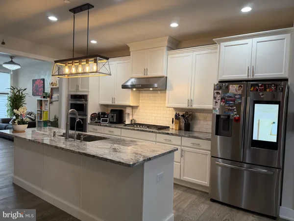 a kitchen with a refrigerator and a sink