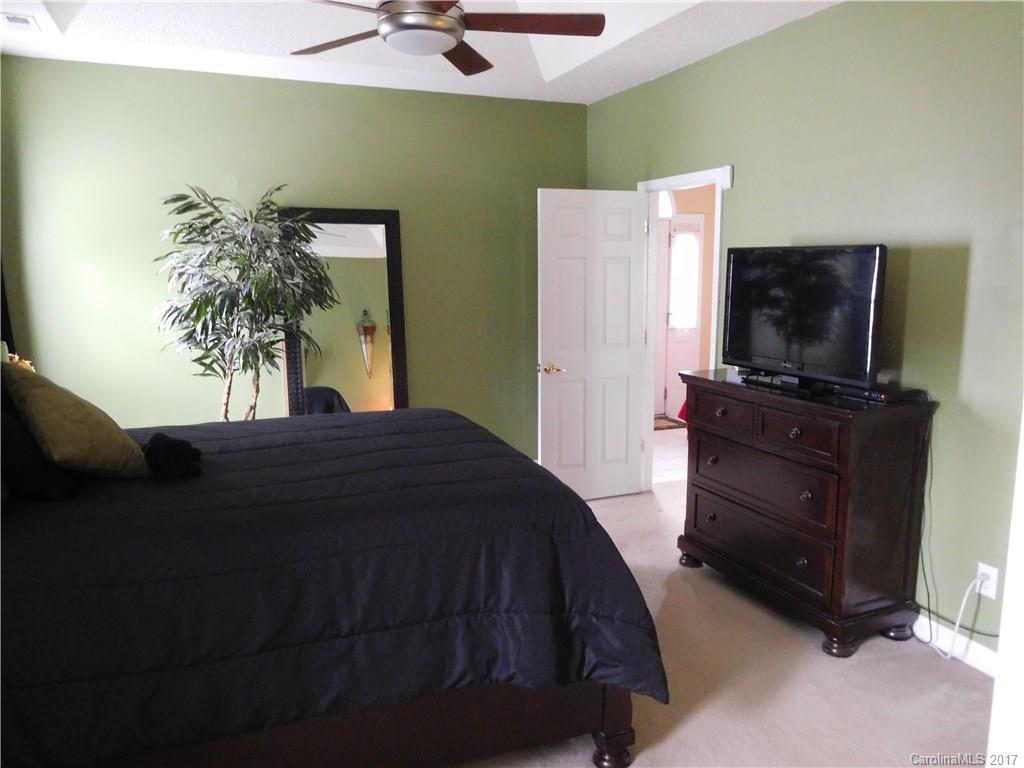 823 Knightsbridge Road Fort Mill, SC 29708 - Photo 13 of 24 a bedroom with a bed and a flat tv screen on dresser