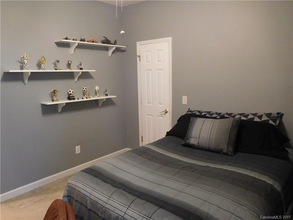 823 Knightsbridge Road Fort Mill, SC 29708 - Photo 18 of 24 a bedroom with a bed and cabinets
