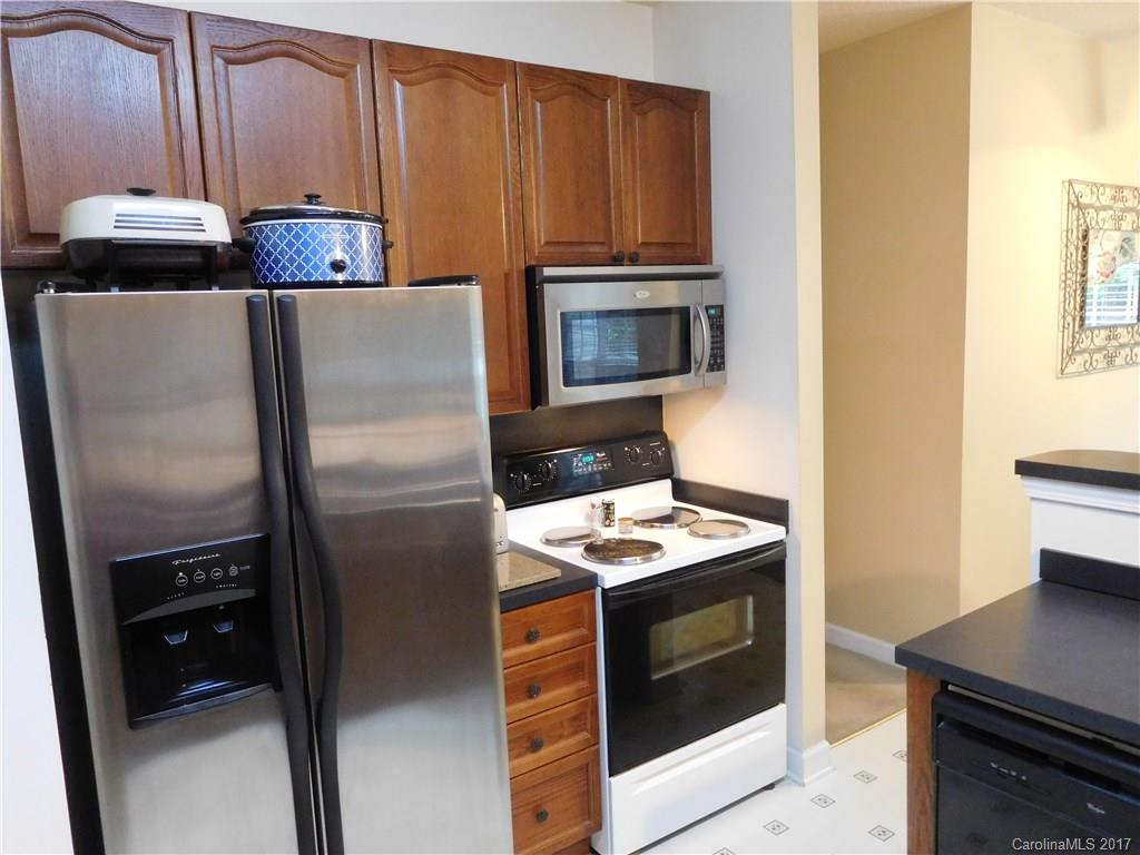 823 Knightsbridge Road Fort Mill, SC 29708 - Photo 4 of 24 a kitchen with stainless steel appliances wooden cabinets and a stove top oven