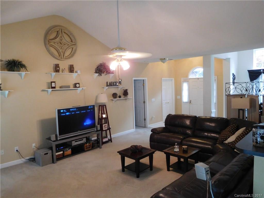823 Knightsbridge Road Fort Mill, SC 29708 - Photo 7 of 24 a living room with furniture a flat screen tv and a fireplace