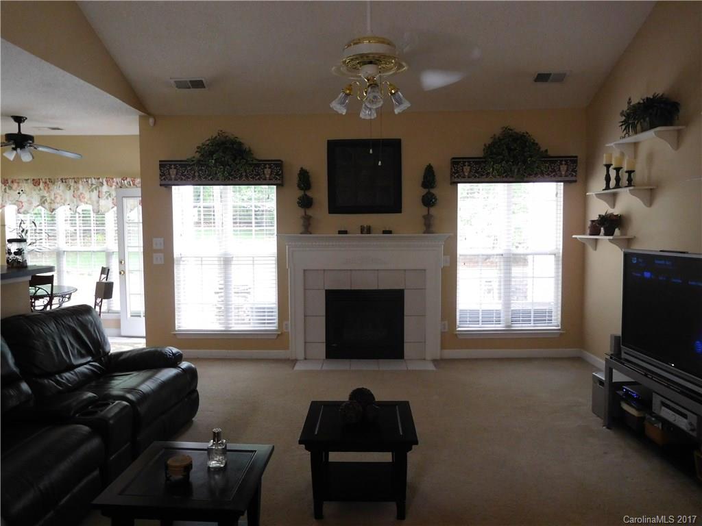 823 Knightsbridge Road Fort Mill, SC 29708 - Photo 8 of 24 a living room with furniture a flat screen tv and a fireplace