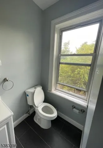 a bathroom with a toilet a sink and a window