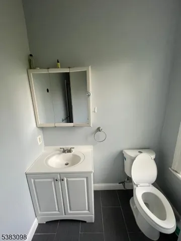 a white toilet sitting next to a bathroom sink