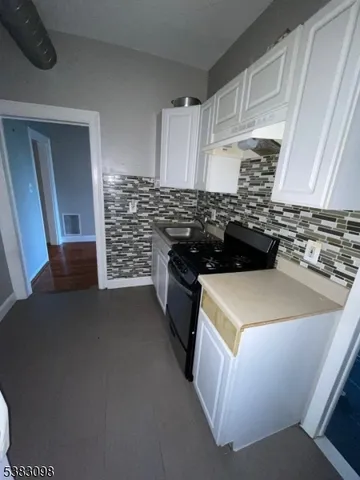 a kitchen with a stove and a refrigerator