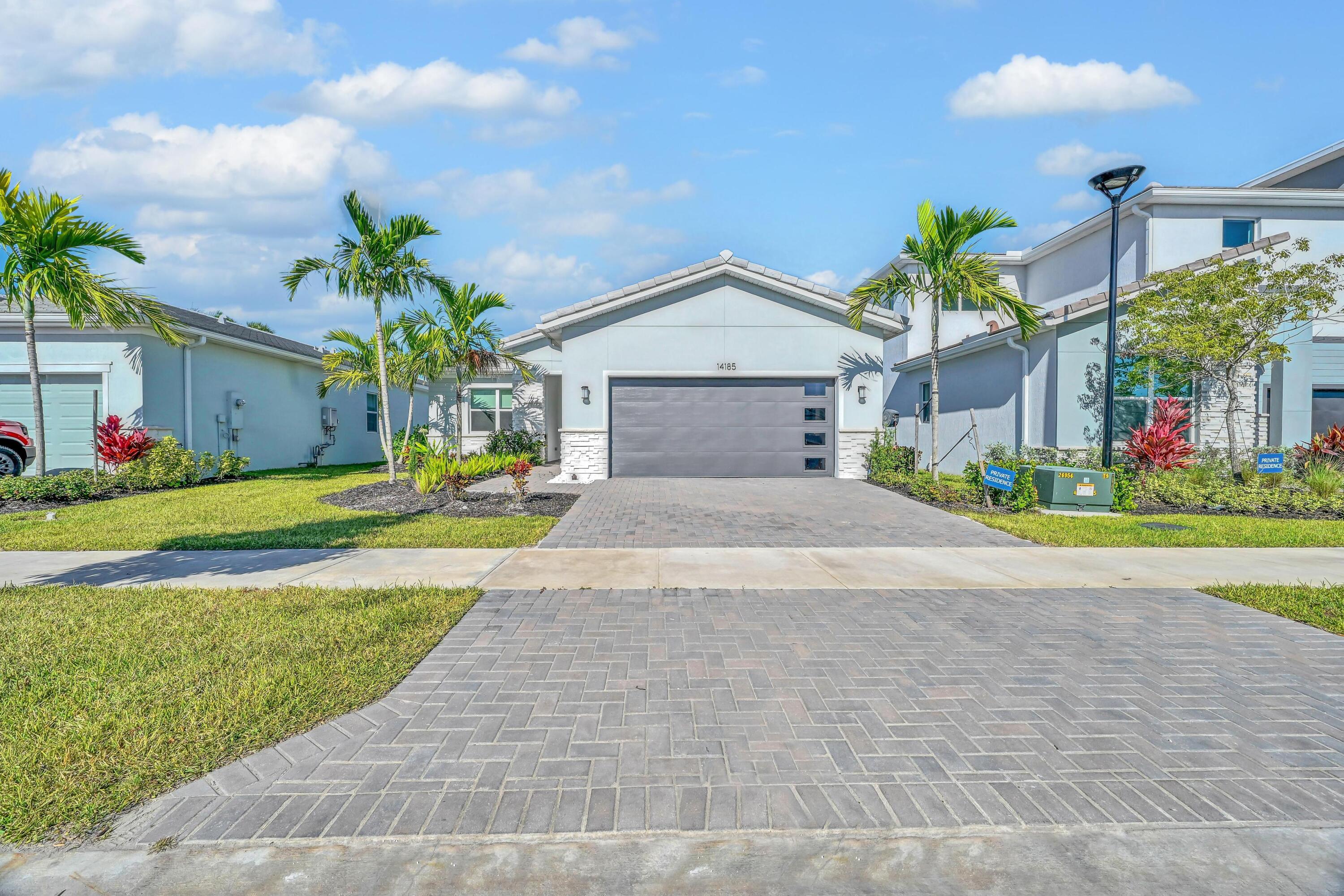 14185 Southwest Daphne St Port Port St. Lucie, FL 34987 - Photo 1 of 46 a front view of house with yard and green space