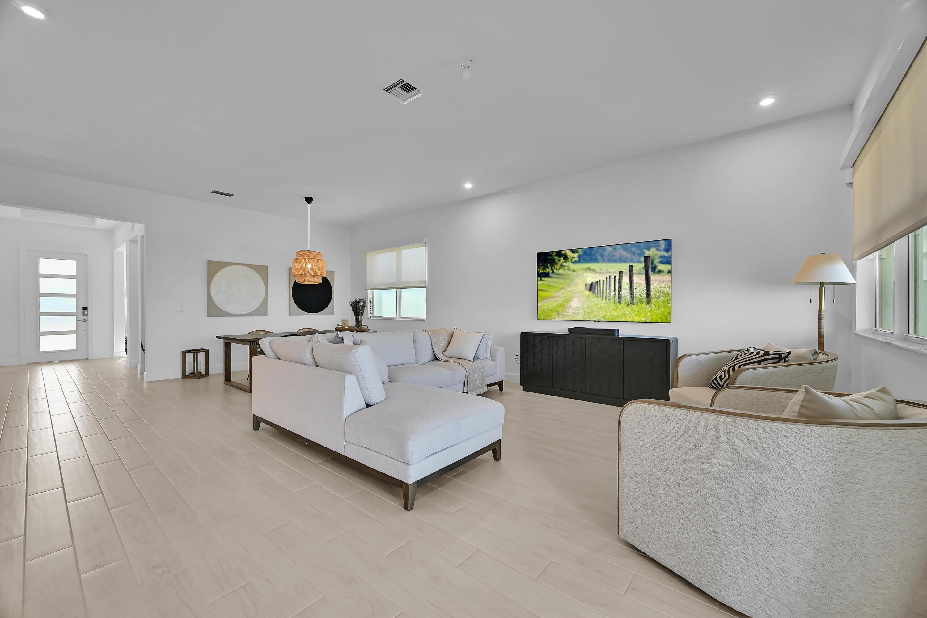 14185 Southwest Daphne St Port Port St. Lucie, FL 34987 - Photo 11 of 46 a living room with furniture and window