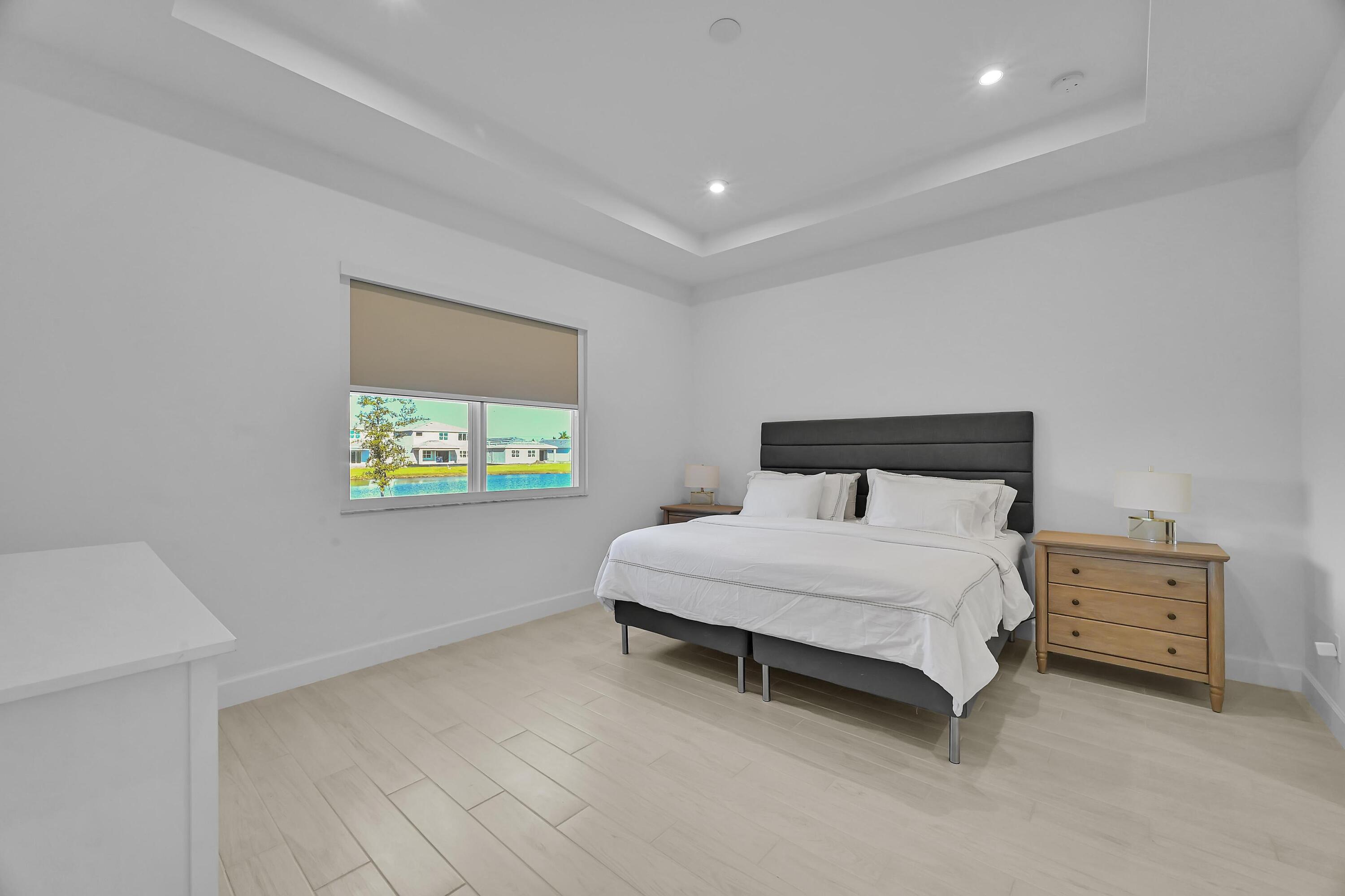 14185 Southwest Daphne St Port Port St. Lucie, FL 34987 - Photo 12 of 46 a bedroom with a bed and a window