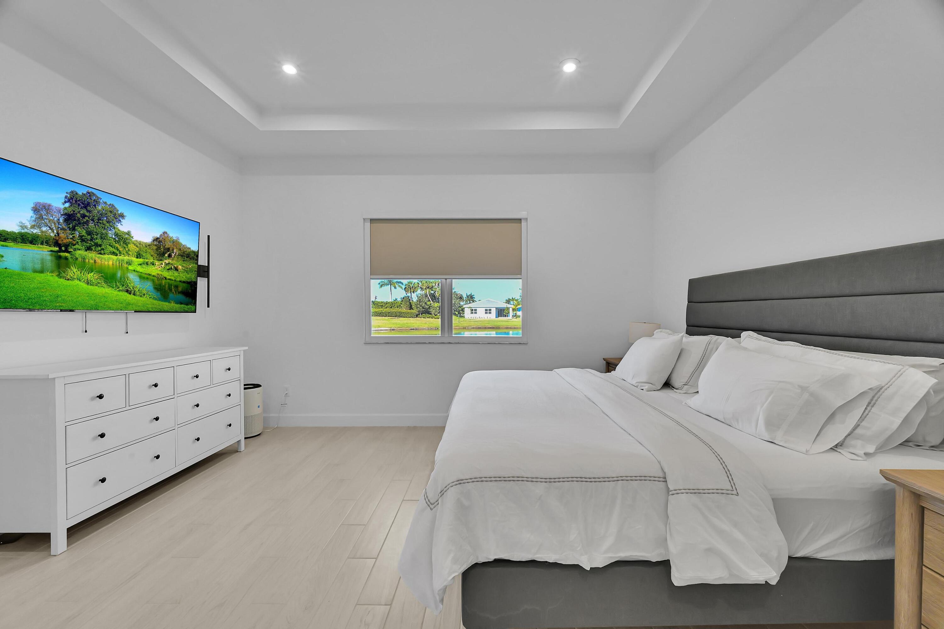 14185 Southwest Daphne St Port Port St. Lucie, FL 34987 - Photo 14 of 46 a bedroom with a bed and a flat screen tv