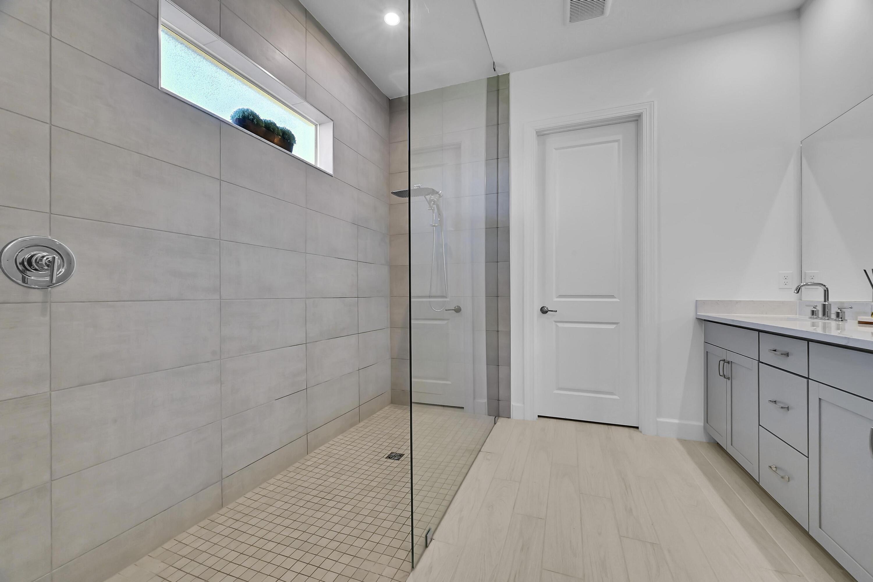 14185 Southwest Daphne St Port Port St. Lucie, FL 34987 - Photo 16 of 46 a bathroom with a granite countertop sink a toilet and shower