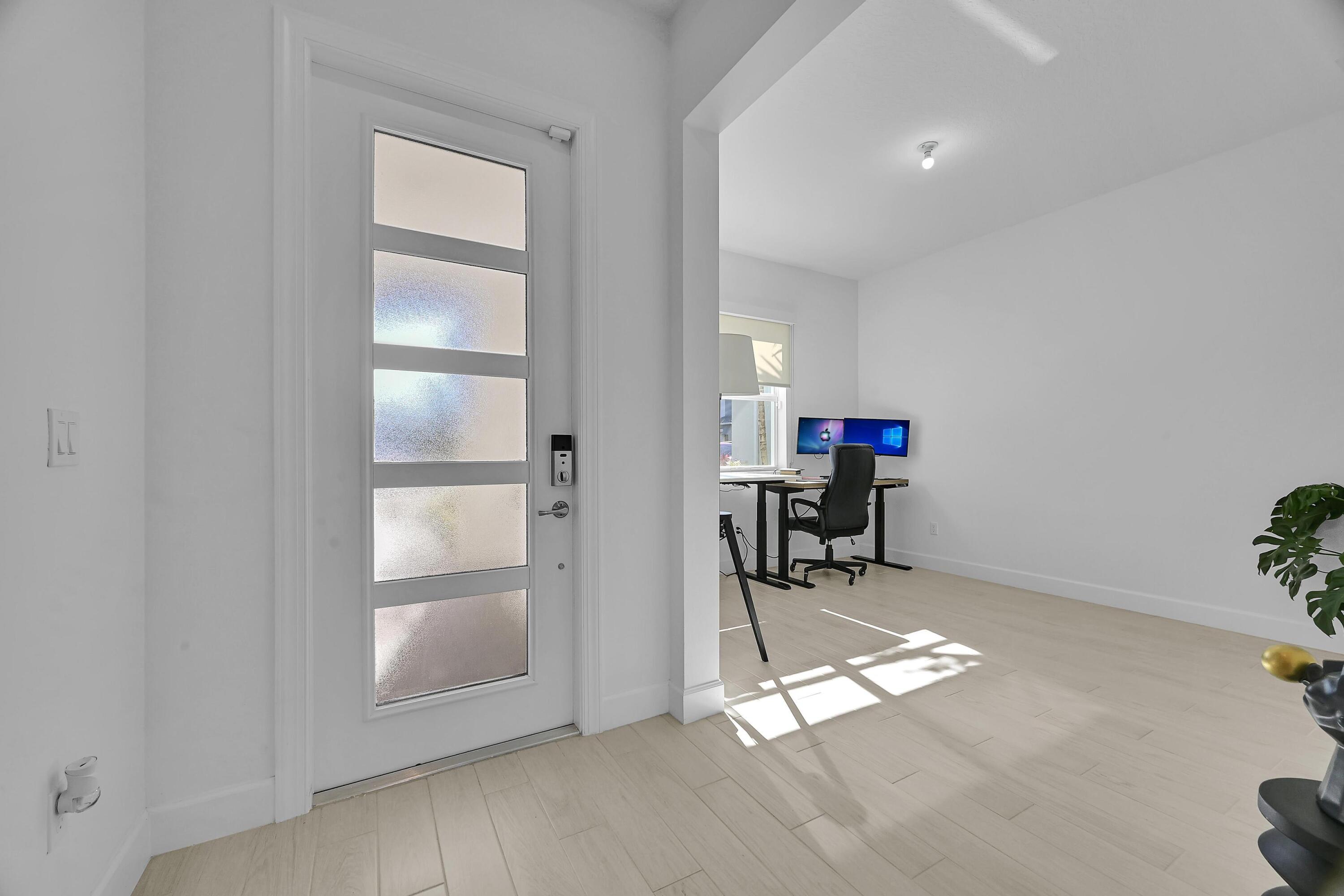 14185 Southwest Daphne St Port Port St. Lucie, FL 34987 - Photo 19 of 46 wooden floor in an empty room with a window