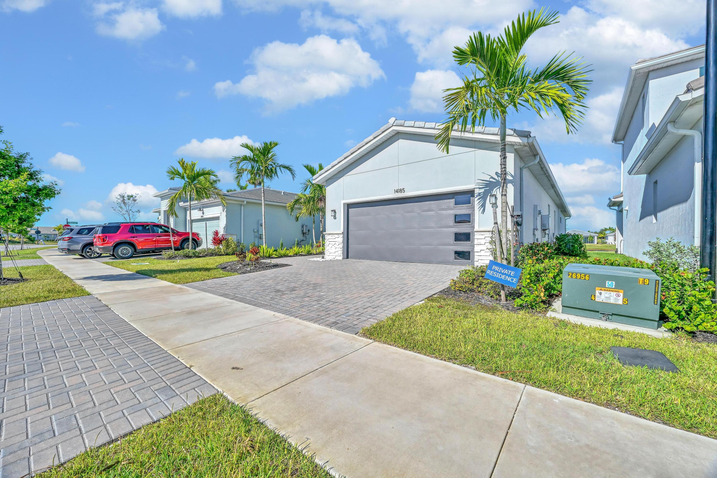 14185 Southwest Daphne St Port Port St. Lucie, FL 34987 - Photo 2 of 46 a front view of house with yard and green space