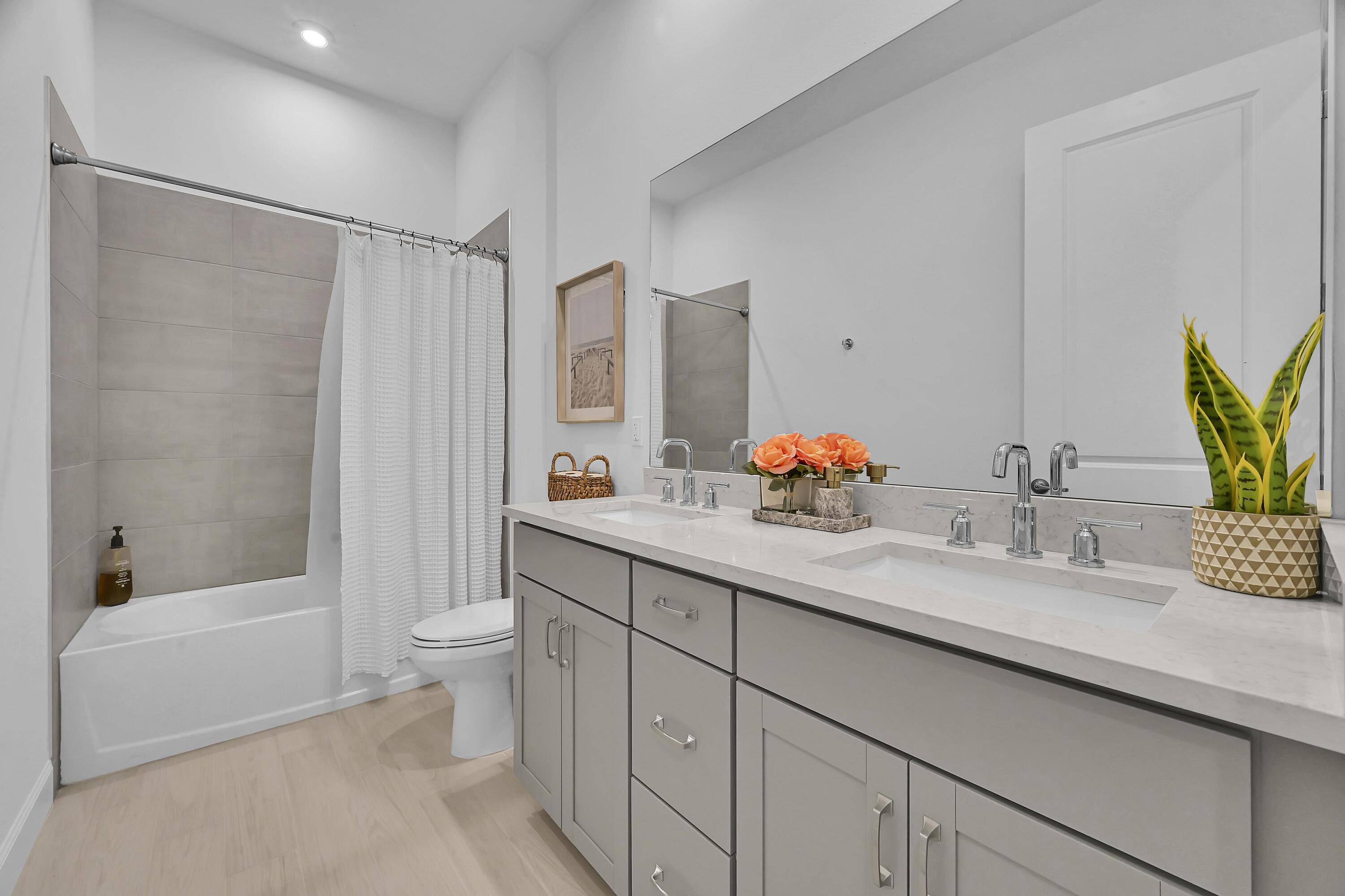 14185 Southwest Daphne St Port Port St. Lucie, FL 34987 - Photo 25 of 46 a bathroom with a granite countertop sink a toilet and shower