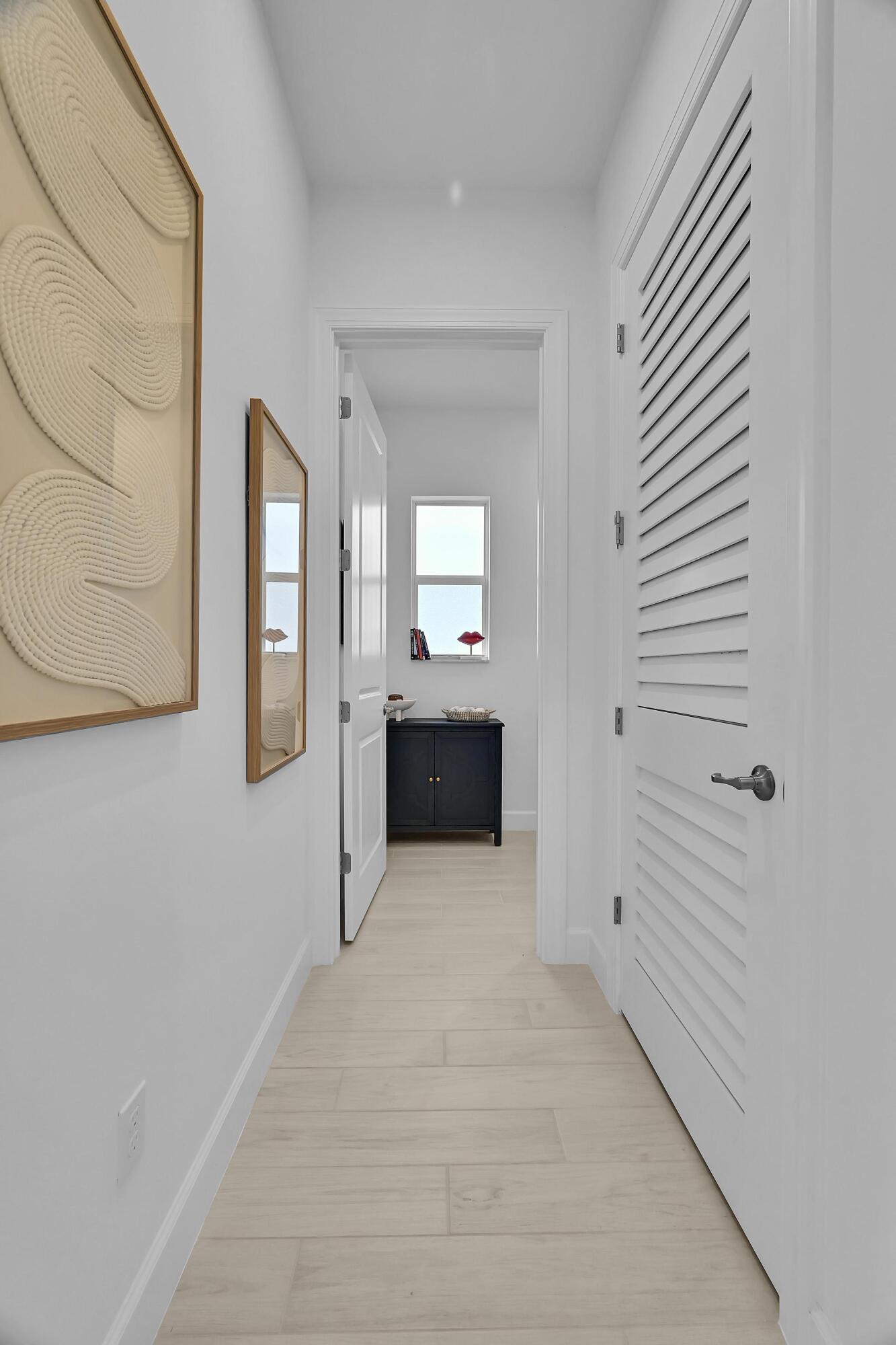 14185 Southwest Daphne St Port Port St. Lucie, FL 34987 - Photo 29 of 46 a view of a hallway with wooden floor and staircase