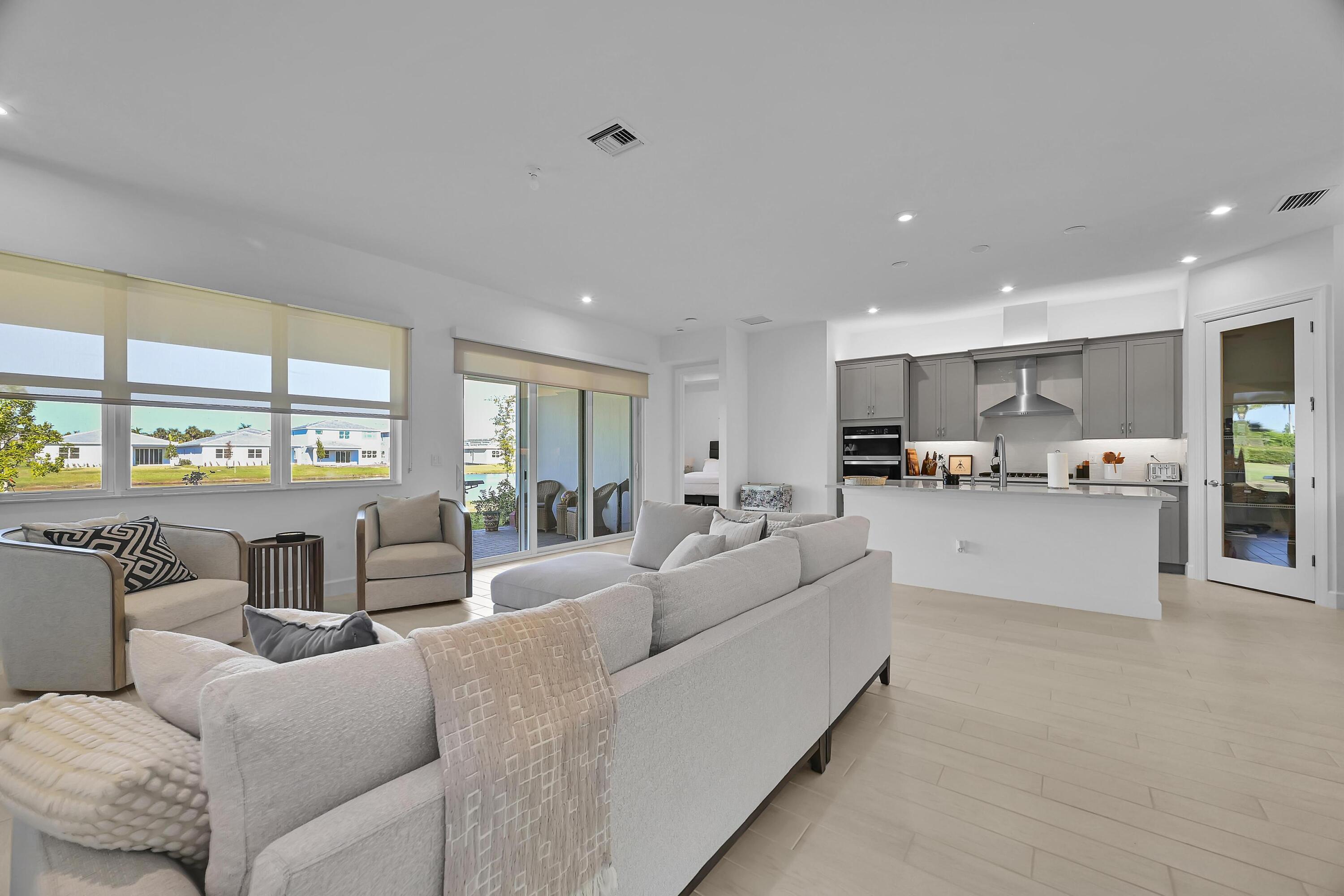 14185 Southwest Daphne St Port Port St. Lucie, FL 34987 - Photo 10 of 46 a living room with furniture and a kitchen view