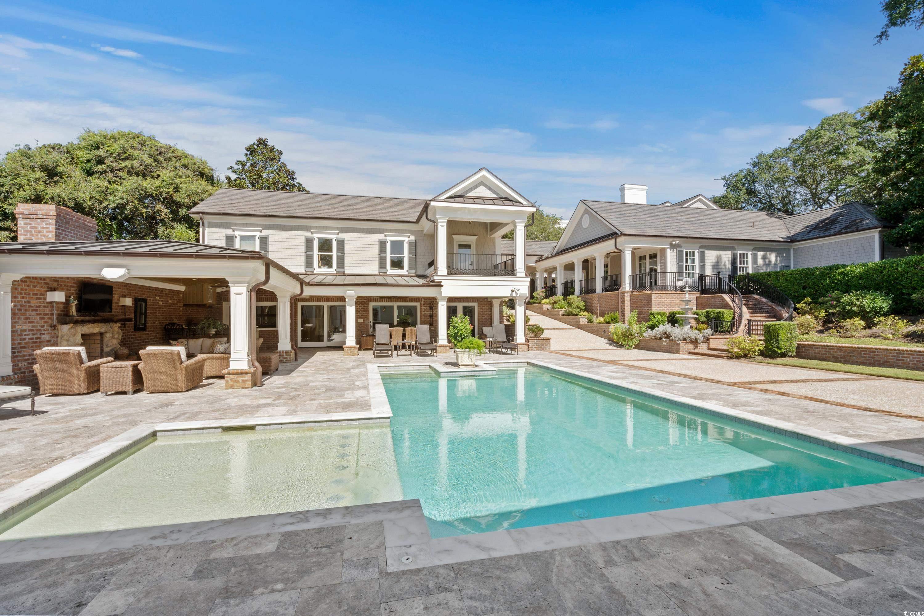 3601 North Ocean Boulevard Myrtle Beach, SC 29577 - Photo 32 of 38 Restore and relax with an outdoor entertaining space that includes a pool, al fresco dining, wood burning fireplace, a sauna and a fitness area.
