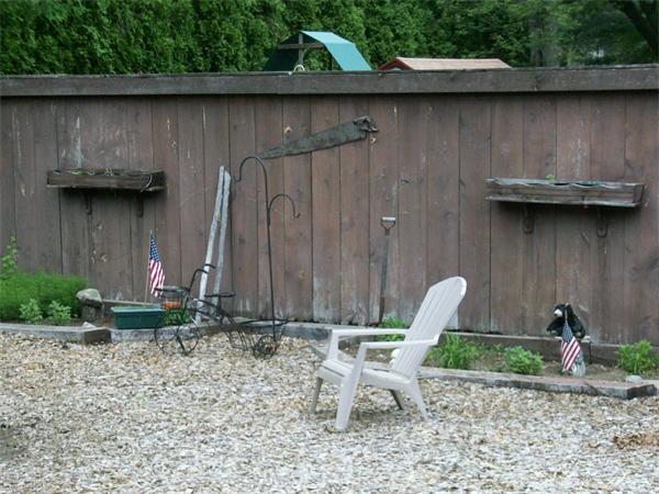 4 Woodlawn Road Freetown, MA 02702 - Photo 26 of 30 a backyard of a house with chairs and a table