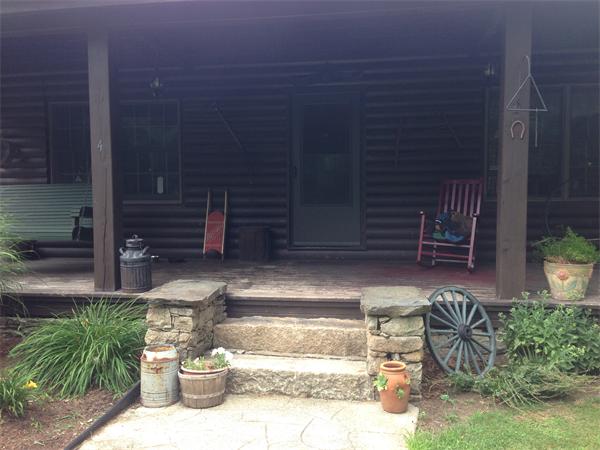 4 Woodlawn Road Freetown, MA 02702 - Photo 4 of 30 a view of front door of house with outdoor seating