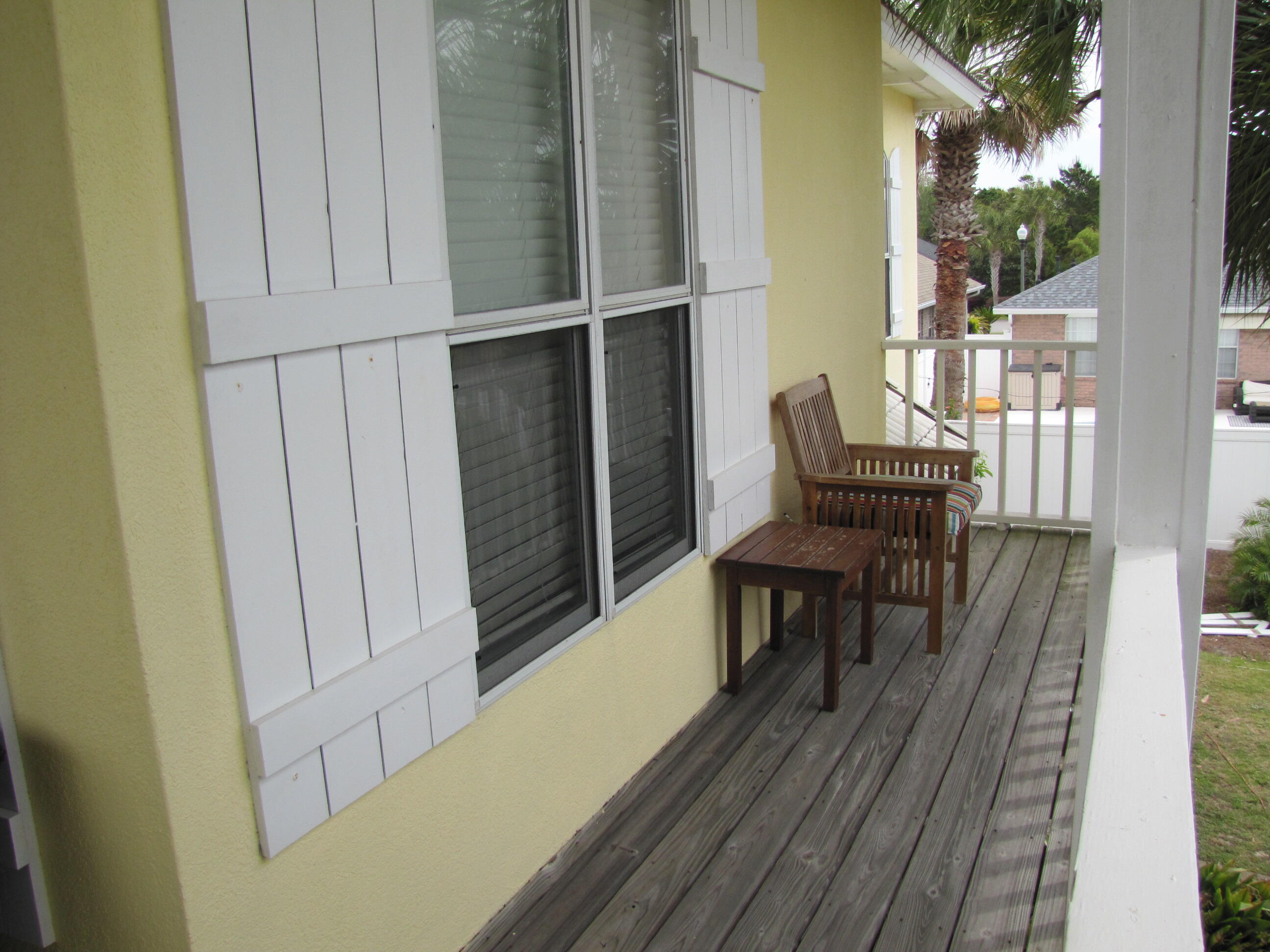 22 Amber Cove Miramar Beach, FL 32550 - Photo 43 of 60 a view of a balcony with furniture and wooden floor