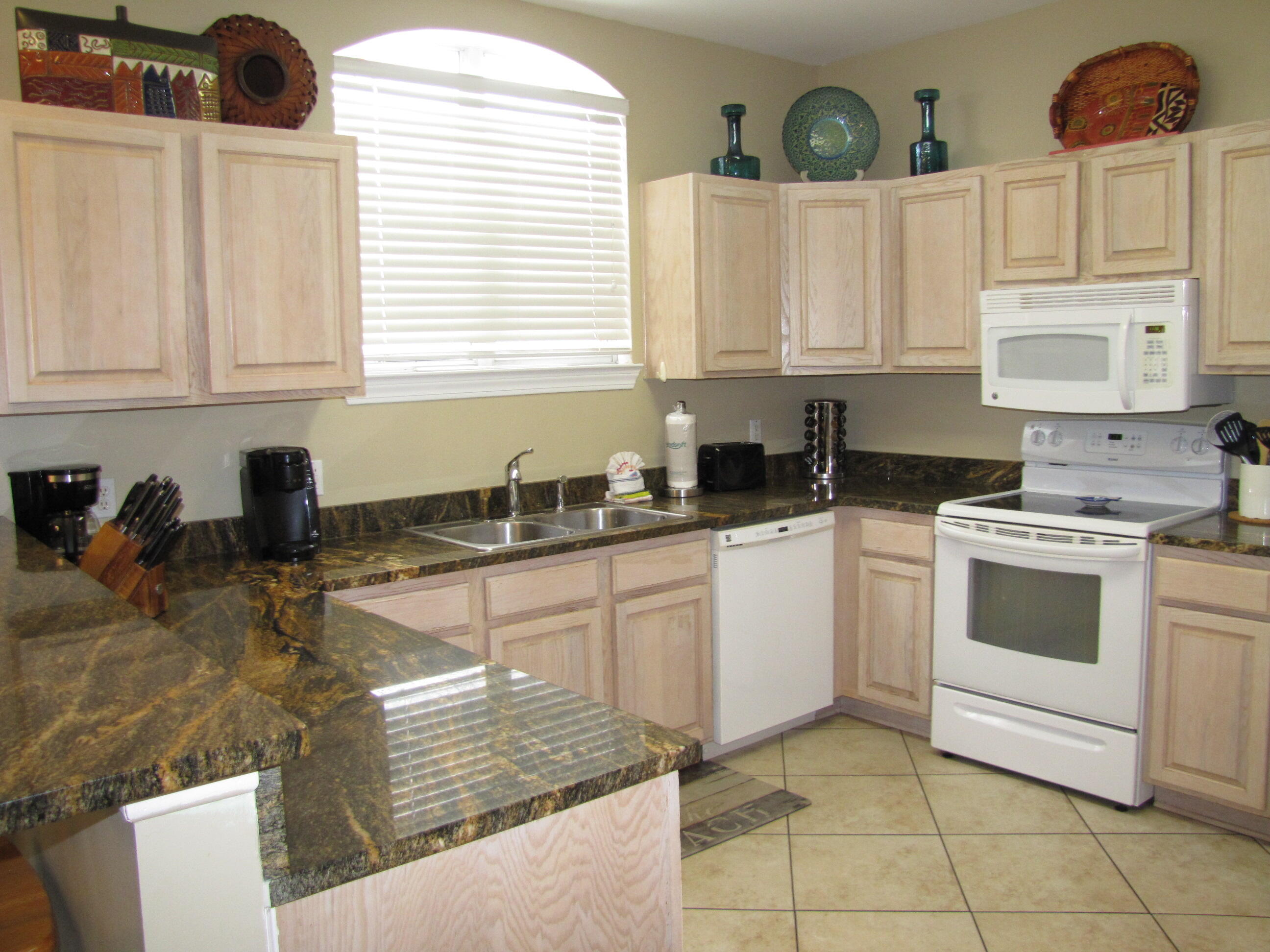 22 Amber Cove Miramar Beach, FL 32550 - Photo 7 of 60 a kitchen with stainless steel appliances granite countertop a sink and cabinets