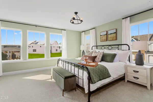 a bedroom with a bed and a large window