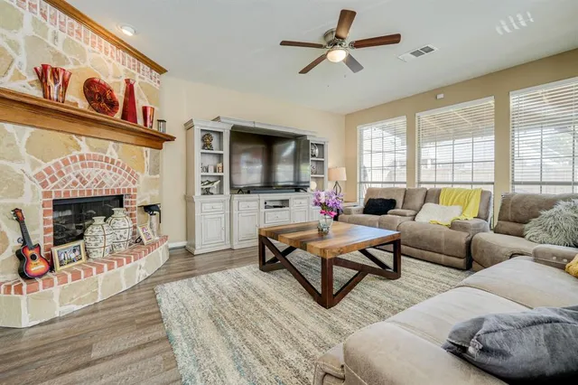 a living room with furniture a fireplace and a flat screen tv