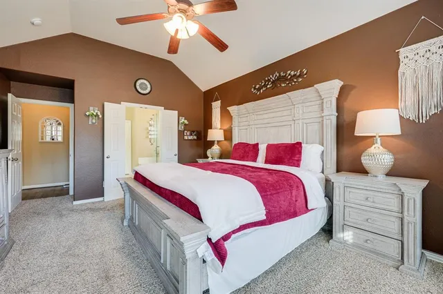 a bedroom with bed and a chandelier