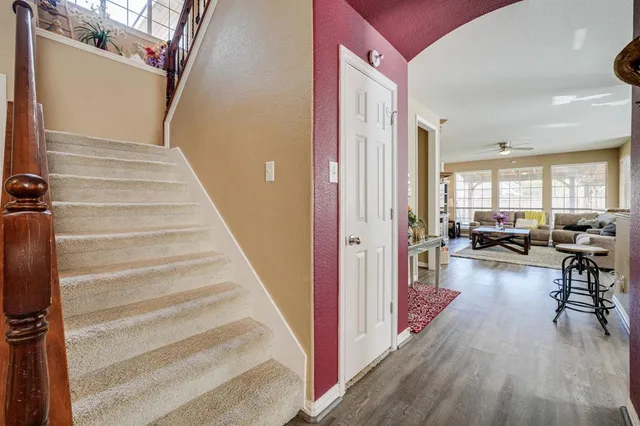 a view of a livingroom with lots of furniture and hardwood floor