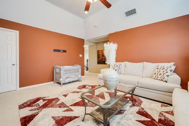 a bedroom with a bed and a chandelier fan