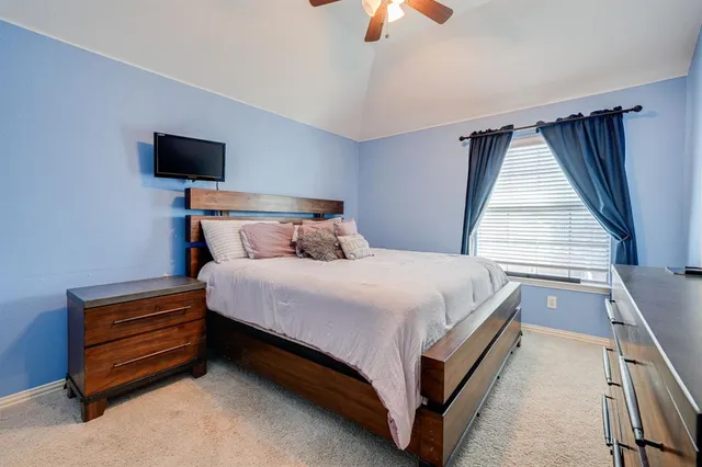 a bed sitting in a room next to a window