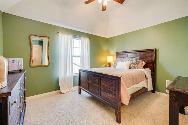 a bed sitting in a room next to a window