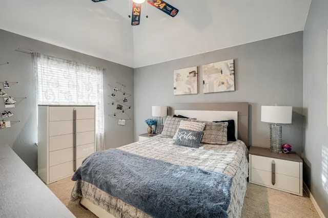 a bedroom with a bed and a lamp