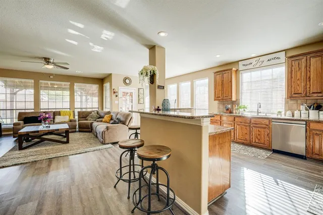 a large white kitchen with lots of counter top space and furniture
