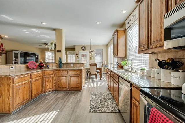 a kitchen with sink stove and cabinets