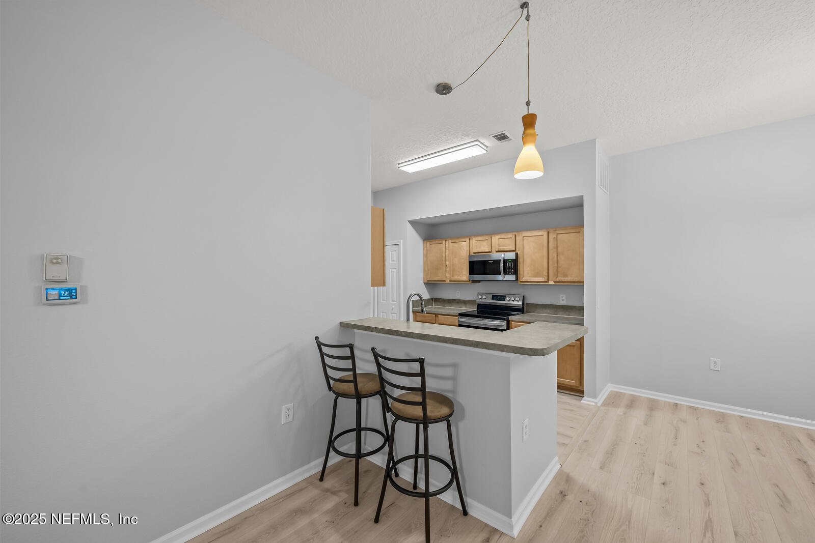 7920 Merrill Road West, Unit 1604 Jacksonville, FL 32277 - Photo 11 of 30 a kitchen with a stove and a refrigerator