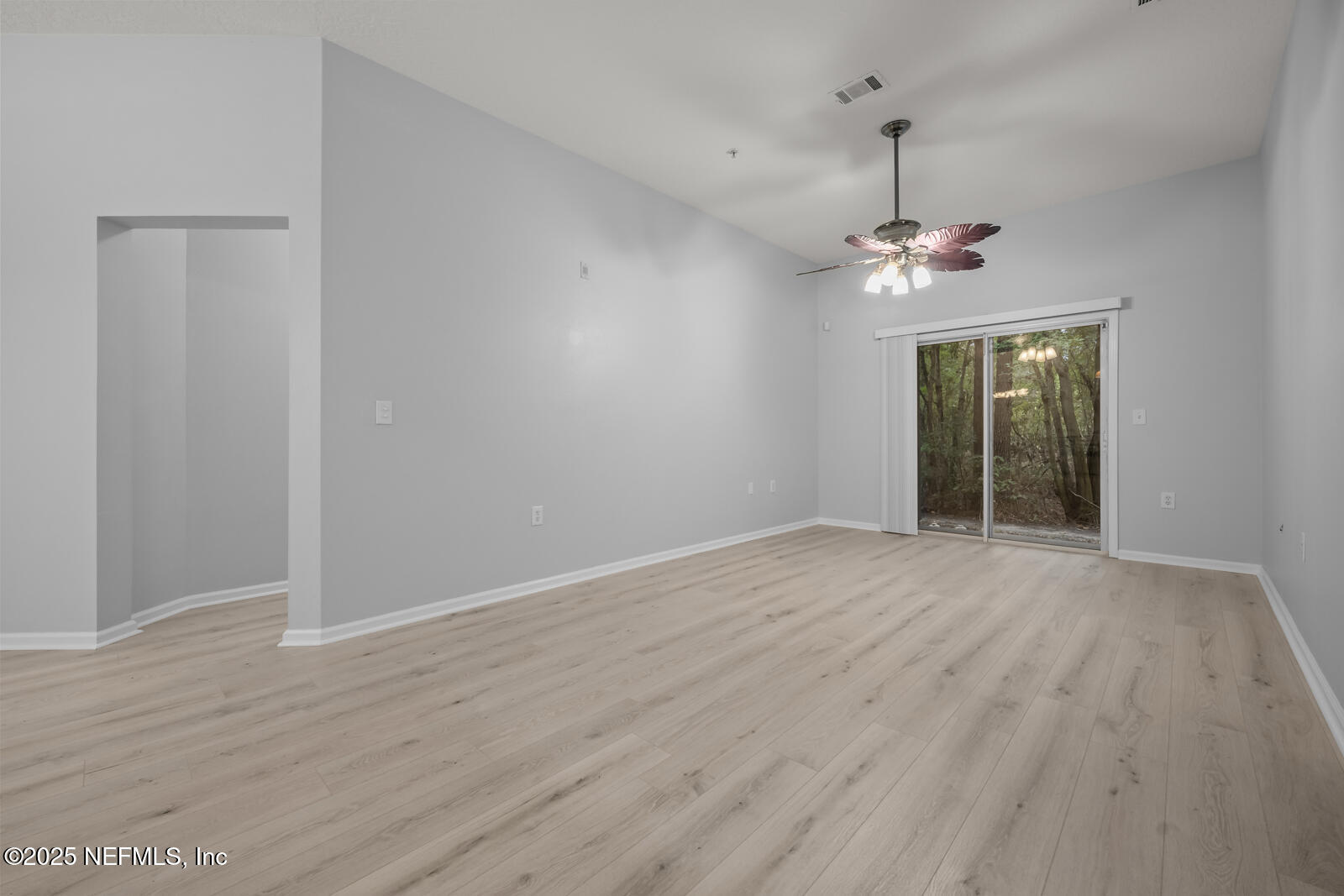 7920 Merrill Road West, Unit 1604 Jacksonville, FL 32277 - Photo 12 of 30 wooden floor in an empty room with a window