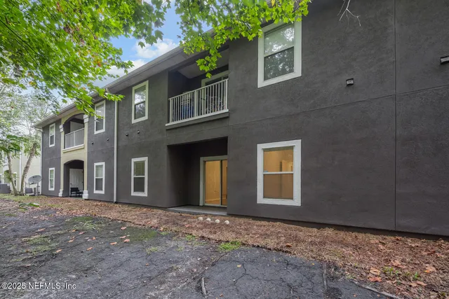 a view of a parked cars in front of a brick house