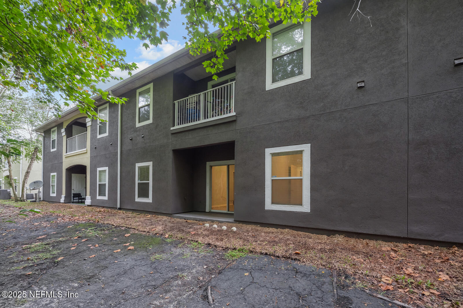 7920 Merrill Road West, Unit 1604 Jacksonville, FL 32277 - Photo 25 of 30 a view of a house with a tree