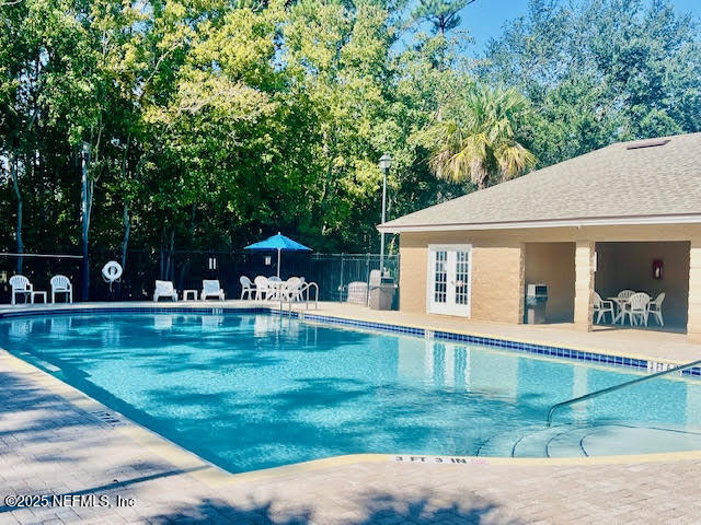 7920 Merrill Road West, Unit 1604 Jacksonville, FL 32277 - Photo 28 of 30 a view of a house with swimming pool and sitting area