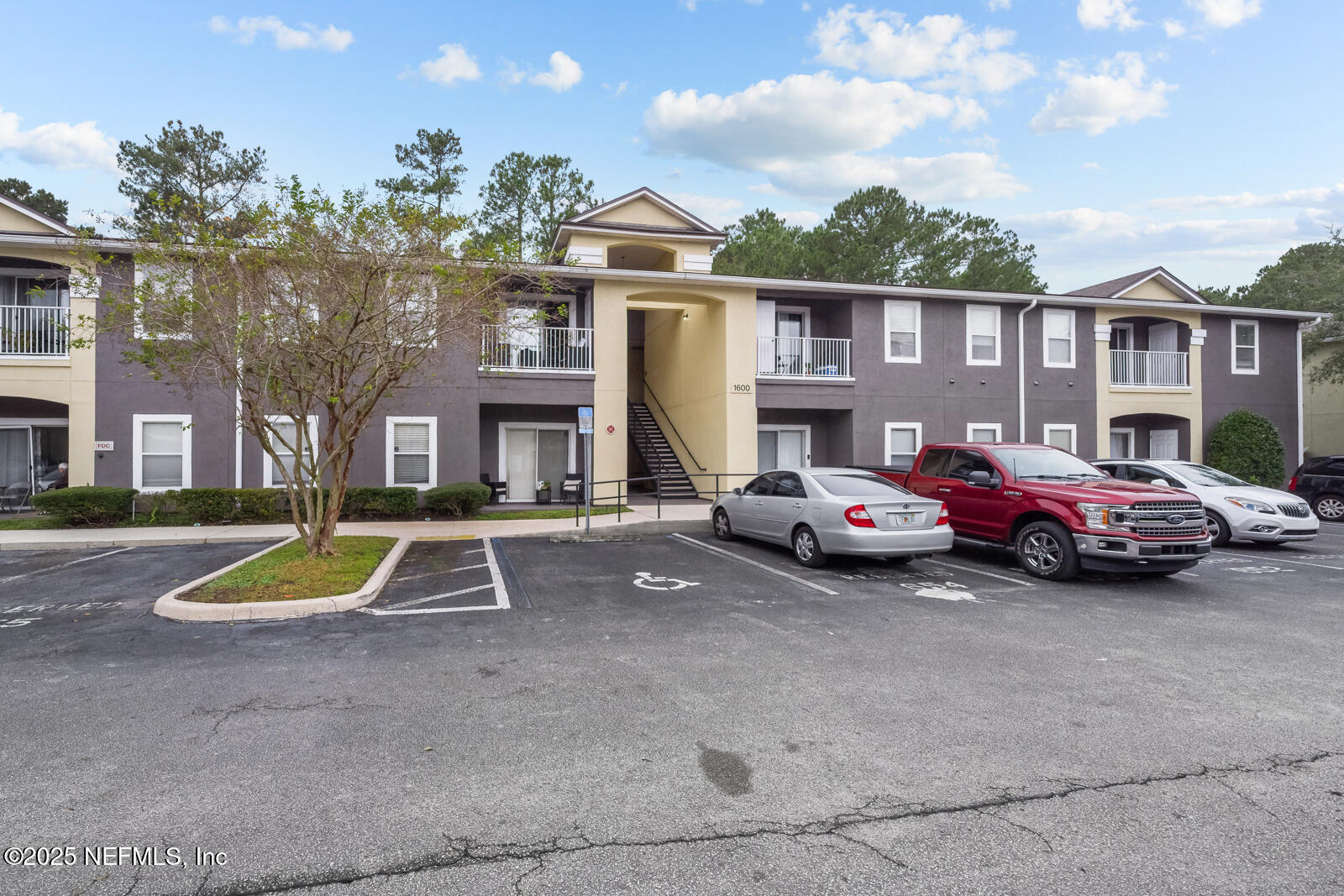 7920 Merrill Road West, Unit 1604 Jacksonville, FL 32277 - Photo 29 of 30 a view of a parked cars in front of a brick house
