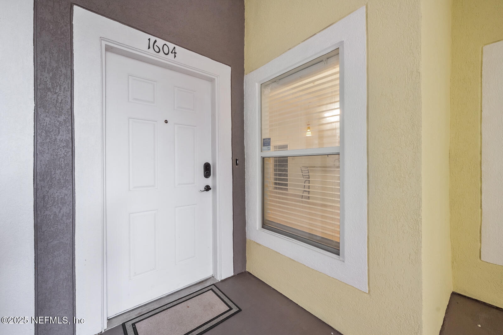 7920 Merrill Road West, Unit 1604 Jacksonville, FL 32277 - Photo 4 of 30 a view of a hallway with front door