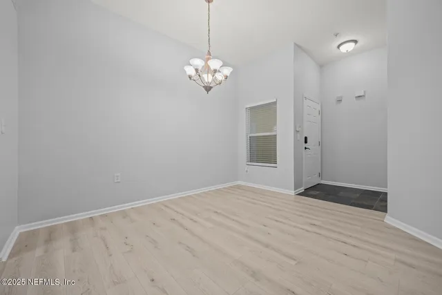 a kitchen with a refrigerator sink and white cabinets