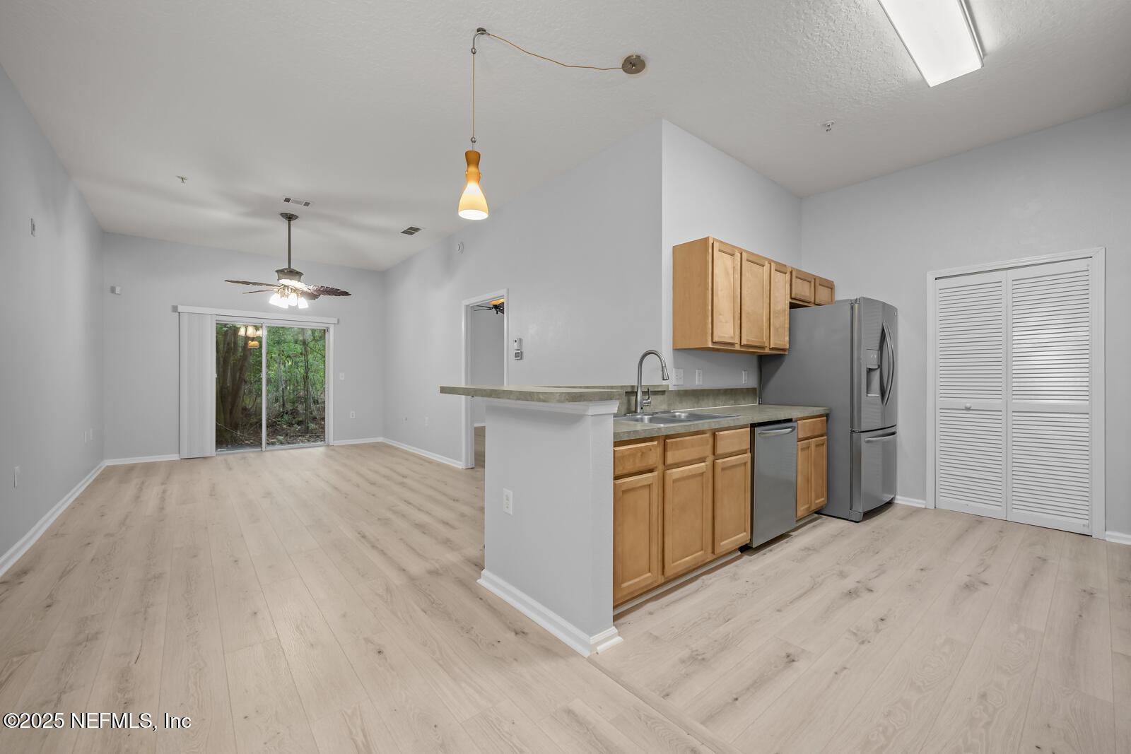 7920 Merrill Road West, Unit 1604 Jacksonville, FL 32277 - Photo 7 of 30 a kitchen with a refrigerator sink and white cabinets
