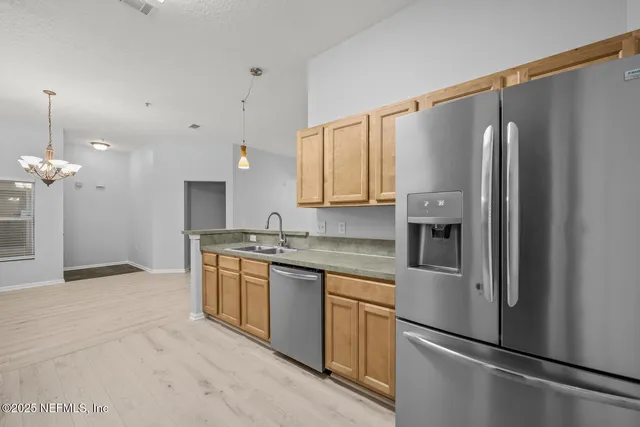 a kitchen with a stove and a refrigerator
