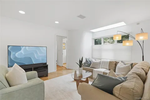 a large bedroom with wooden floor and large window
