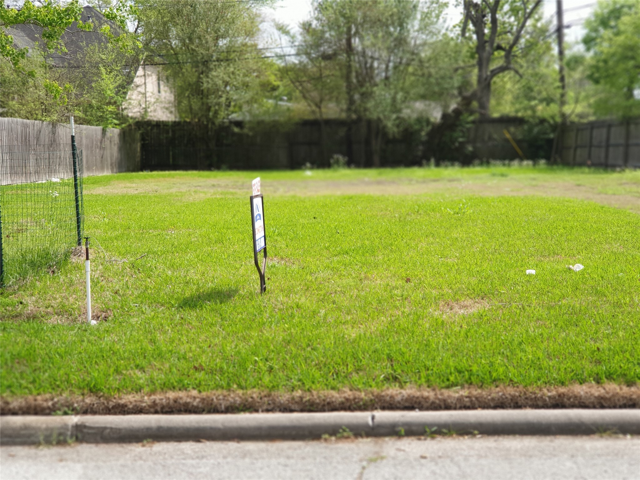a view of a field with a bench in the background